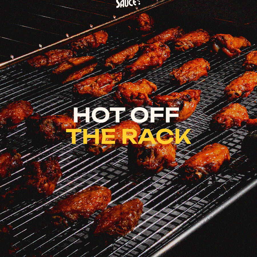 Kraft takeout boxes of wings and fries across a wood table