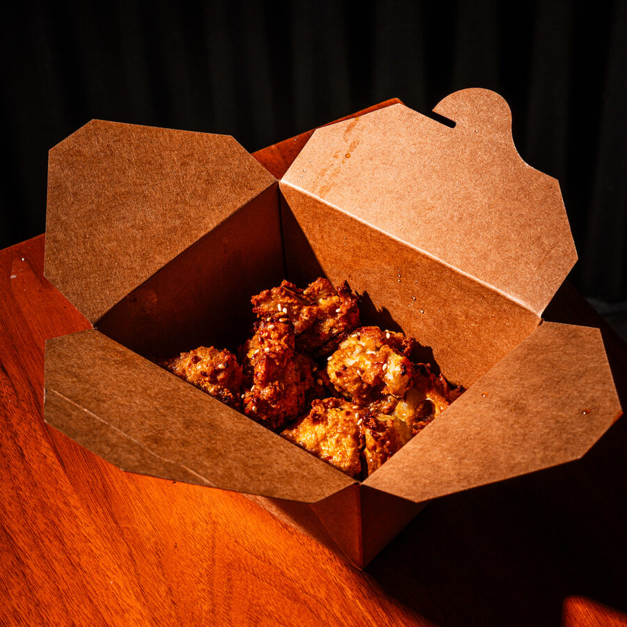 Crispy baked wings tossed in sauce, close up